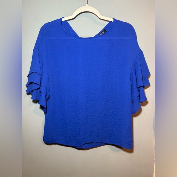 The a.n.a Blue Ruffled Short Sleeve Blouse ties in the back for added detail. - Picture 1 of 6